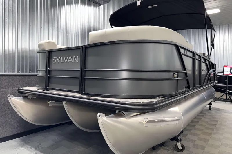 Slide: The Image of 2026 Sylvan Mirage X1 pontoon boat in showroom, sleek design, metallic finish. - 19
