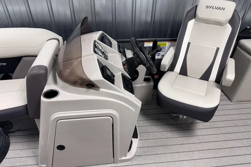 Slide: The Image of 2026 Sylvan Mirage X1 boat interior with modern helm and comfortable captain's chair. - 6