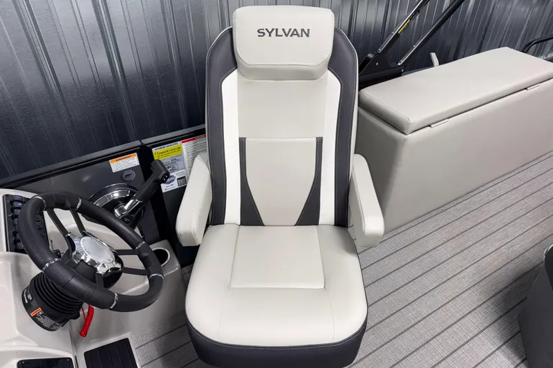 Slide: The Image of 2026 Sylvan Mirage X1 boat interior with steering wheel and captain's chair. - 8
