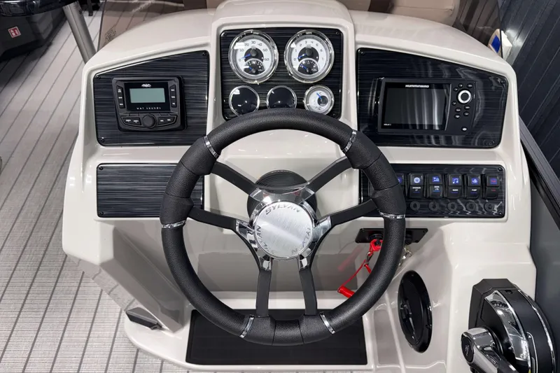 Slide: The Image of 2026 Sylvan Mirage X1 boat dashboard with steering wheel, gauges, and control panel. - 9