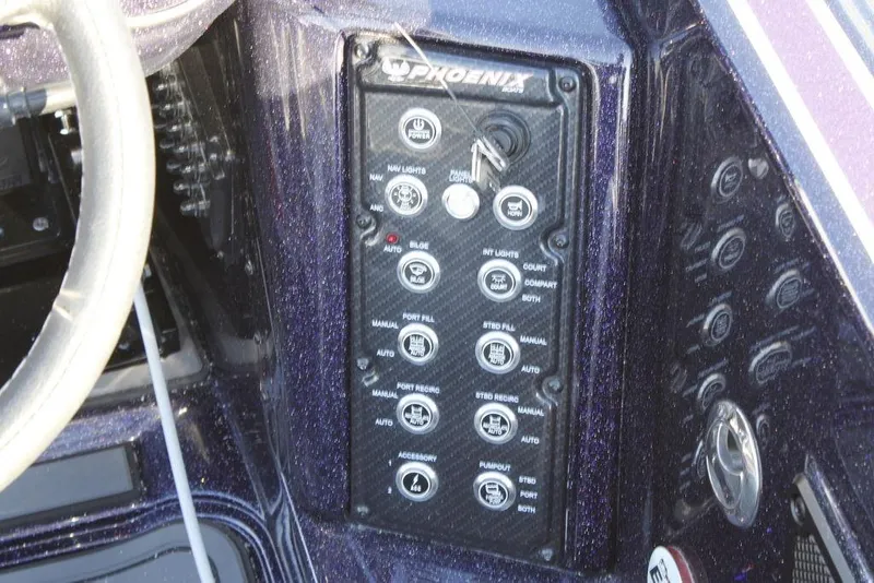 Slide: The Image of Control panel of a 2026 Phoenix 21 boat with various switches and buttons. - 15