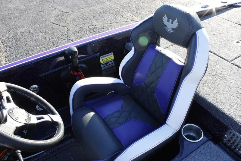 Slide: The Image of 2026 Phoenix 21 boat interior with purple and black seat, steering wheel, and cup holder. - 16