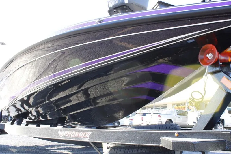 Slide: The Image of 2026 Phoenix 21 boat on trailer, sleek black and purple design. - 25