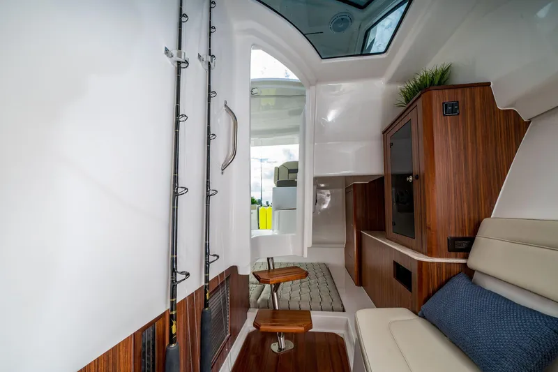 Slide: The Image of Control panel of 2026 Pursuit DC 365 Dual Console boat with joystick and throttle. - 16