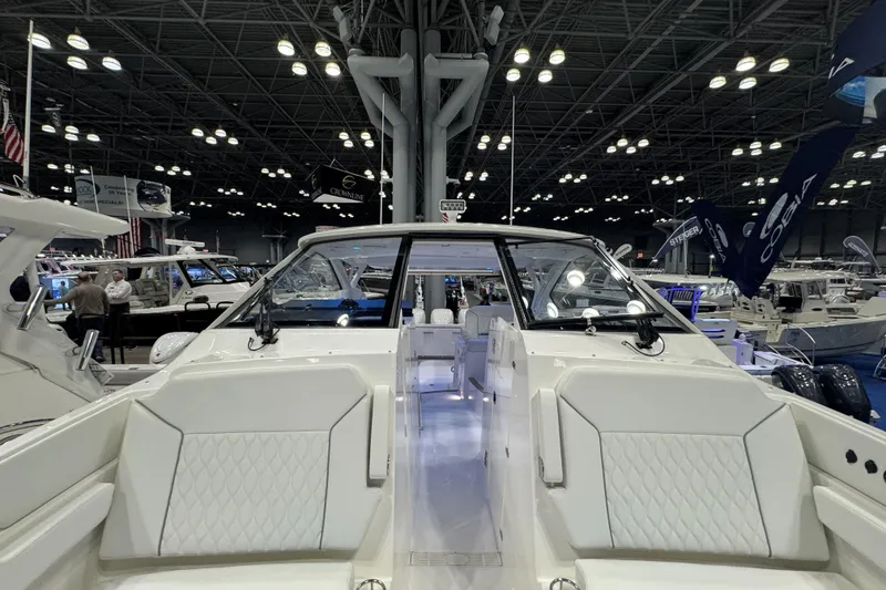 Slide: The Image of 2026 Pursuit DC 365 Dual Console boat showcased at an indoor exhibition. - 25