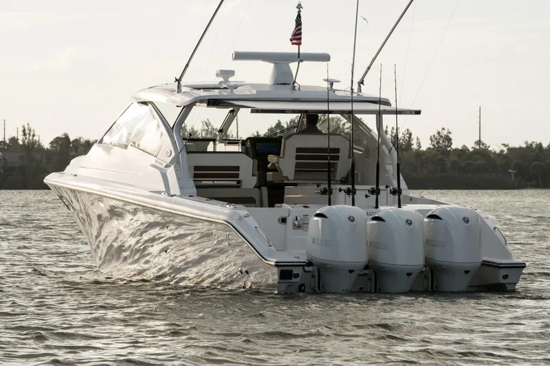 Slide: The Image of 2026 Pursuit DC 365 Dual Console with triple Yamaha outboard engines at a boat show. - 3