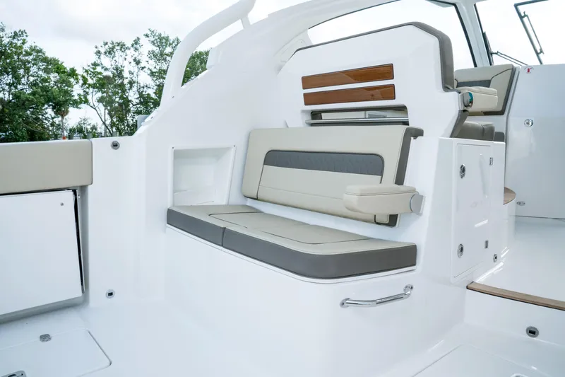 Slide: The Image of 2026 Pursuit DC 365 Dual Console boat interior at a boat show. - 7