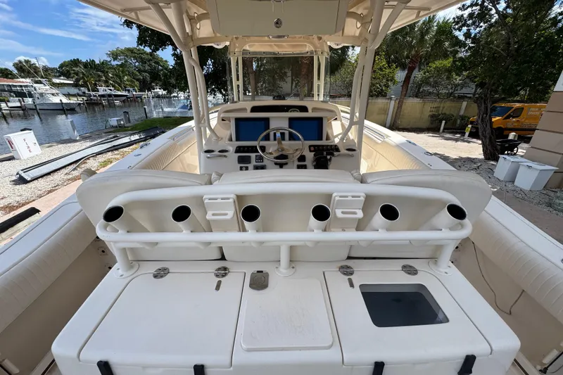 Slide: The Image of 2014 Grady-White Canyon 336 boat interior with rod holders and control panel. - 10