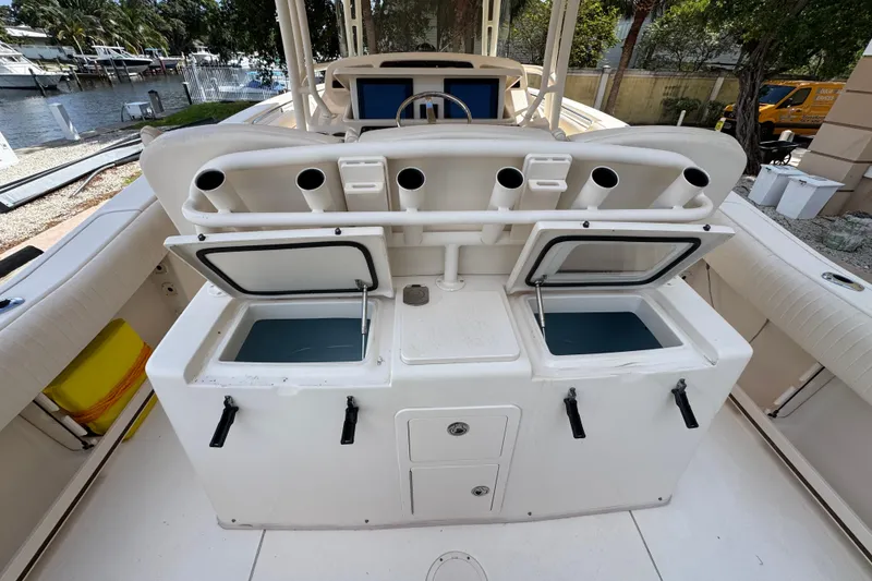 Slide: The Image of 2014 Grady-White Canyon 336 boat with open storage compartments and rod holders. - 11
