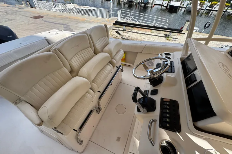 Slide: The Image of 2014 Grady-White Canyon 336 boat interior with helm and seating area. - 13