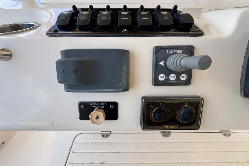 Slide: The Image of Control panel of 2014 Grady-White Canyon 336 boat with switches and joystick. - 16