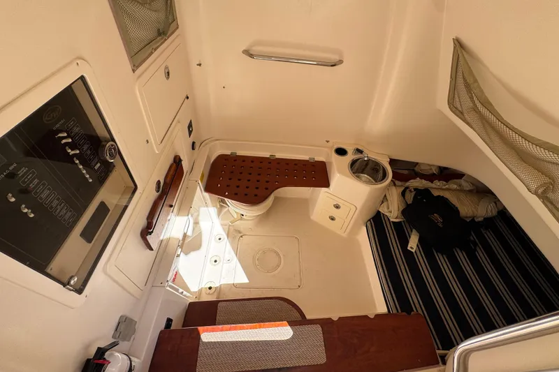 Slide: The Image of Interior of 2014 Grady-White Canyon 336 boat, featuring compact cabin amenities. - 17