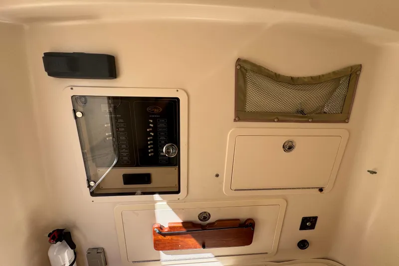Slide: The Image of 2014 Grady-White Canyon 336 boat interior with control panel and storage compartments. - 18