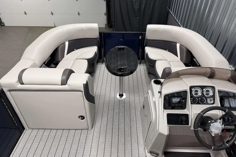 Slide: The Image of 2026 Sylvan MIRAGE X1 CLZ DH boat interior with plush seating and modern dashboard. - 4