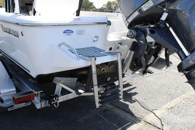 Slide: The Image of 2026 Tidewater 2110 Bay Max boat with motor and swim ladder on trailer. - 10