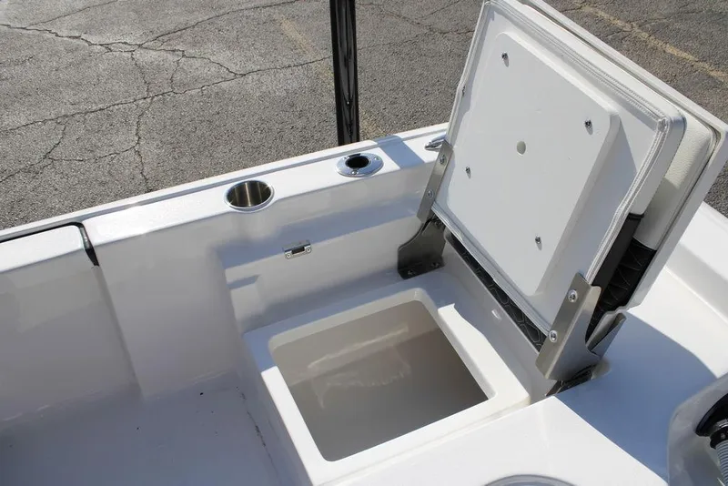 Slide: The Image of 2026 Tidewater 2110 Bay Max boat with open storage compartment and cup holder. - 11