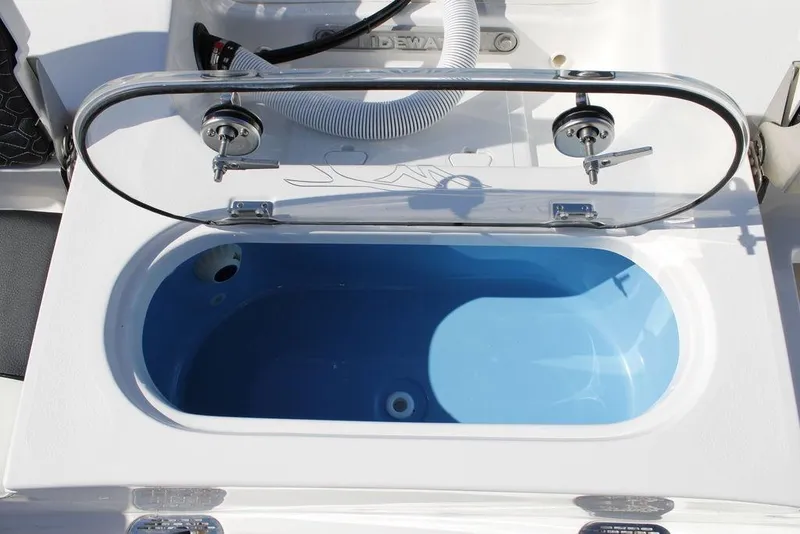Slide: The Image of Livewell on 2026 Tidewater 2110 Bay Max boat, open lid, blue interior. - 12