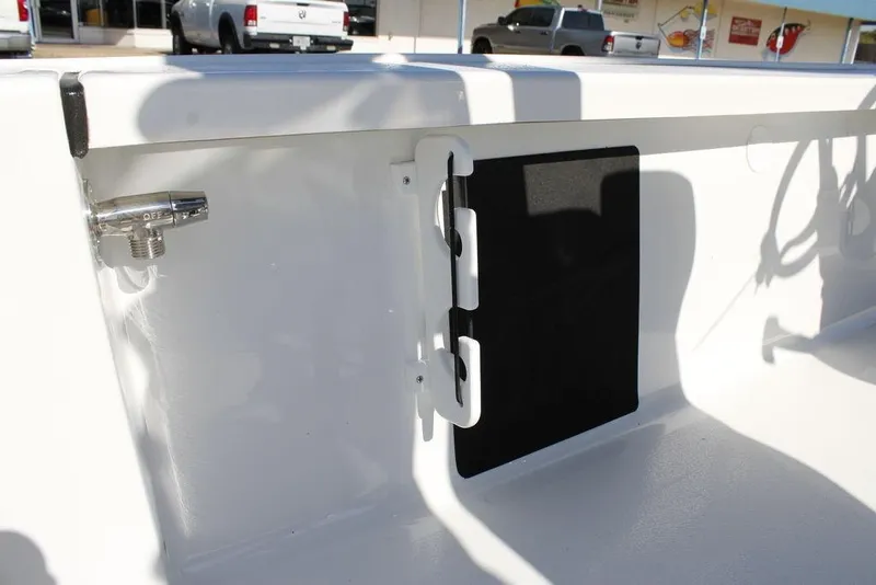 Slide: The Image of 2026 Tidewater 2110 Bay Max boat interior detail with valve and storage compartment. - 18