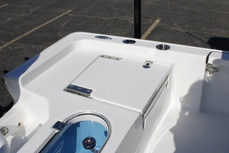 Slide: The Image of 2026 Tidewater 2110 Bay Max boat deck with storage compartment and cup holder. - 20