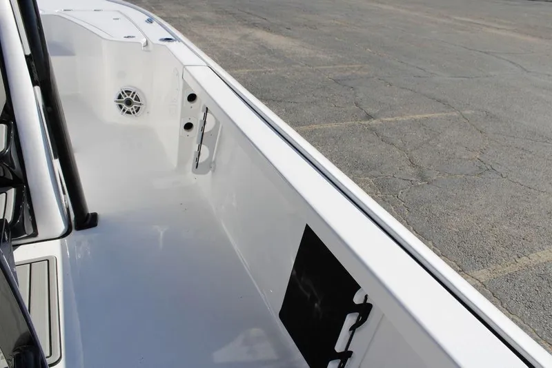 Slide: The Image of 2026 Tidewater 2110 Bay Max boat interior, featuring sleek white design and speaker detail. - 24