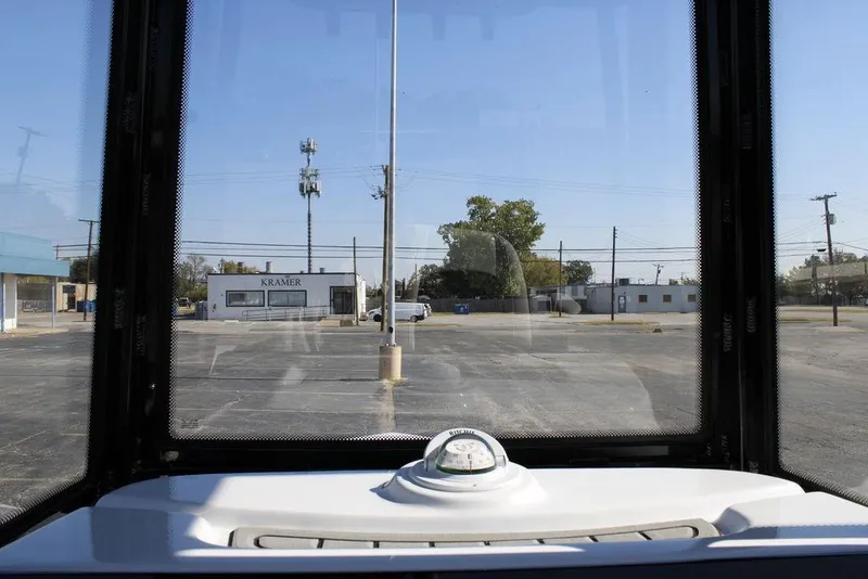 Slide: The Image of View from Tidewater 2110 Bay Max 2026 boat, showing parking lot and buildings. - 26