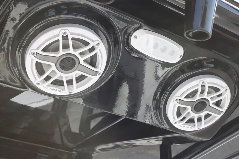 Slide: The Image of 2026 Tidewater 2110 Bay Max boat speakers and light on glossy black surface. - 27