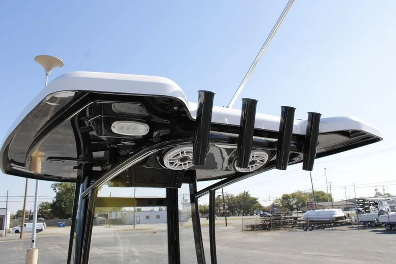 Slide: The Image of Tidewater 2110 Bay Max 2026 boat T-top with rod holders and speakers. - 28