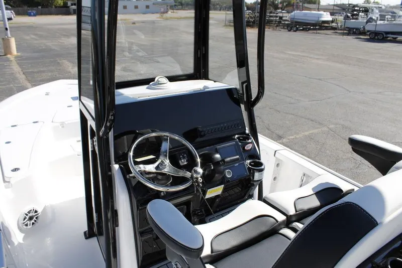 Slide: The Image of 2026 Tidewater 2110 Bay Max boat interior with steering console and seating. - 32