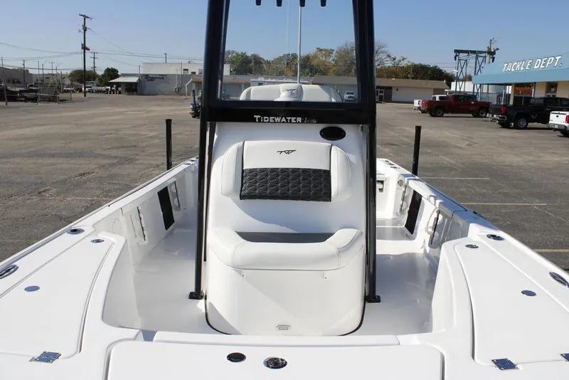 Slide: The Image of 2026 Tidewater 2110 Bay Max boat, white interior, parked in a lot near tackle shop. - 38