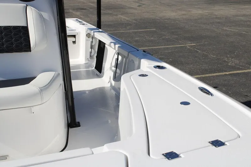 Slide: The Image of 2026 Tidewater 2110 Bay Max boat interior with white seating and storage compartments. - 40