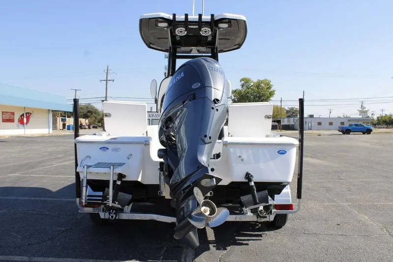 Slide: The Image of 2026 Tidewater 2110 Bay Max boat with Yamaha outboard motor, rear view in parking lot. - 5