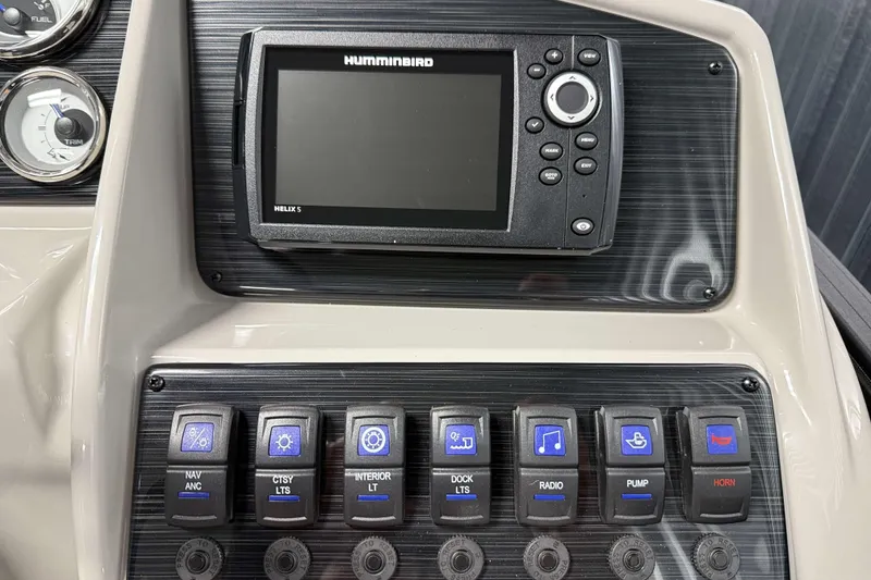 Slide: The Image of Control panel of 2026 Sylvan Mirage X3 with Humminbird Helix 5 and various switches. - 11
