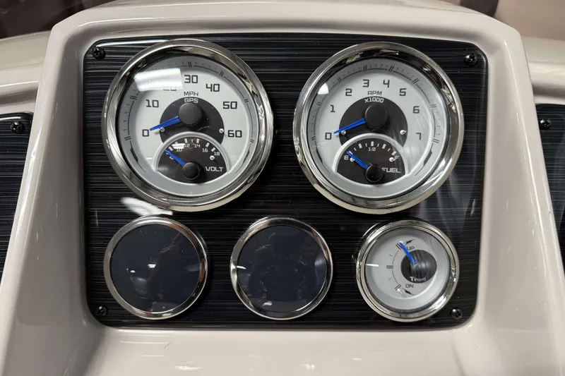 Slide: The Image of Dashboard gauges of 2026 Sylvan Mirage X3 boat, featuring speedometer, tachometer, and fuel indicators. - 12