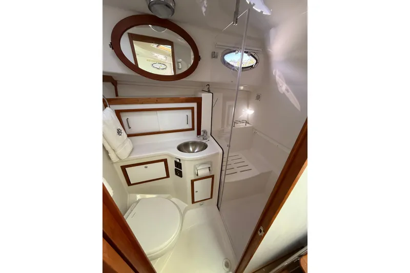 Slide: The Image of 2019 Back Cove Downeast 37 yacht bathroom with sink, toilet, and shower. - 13