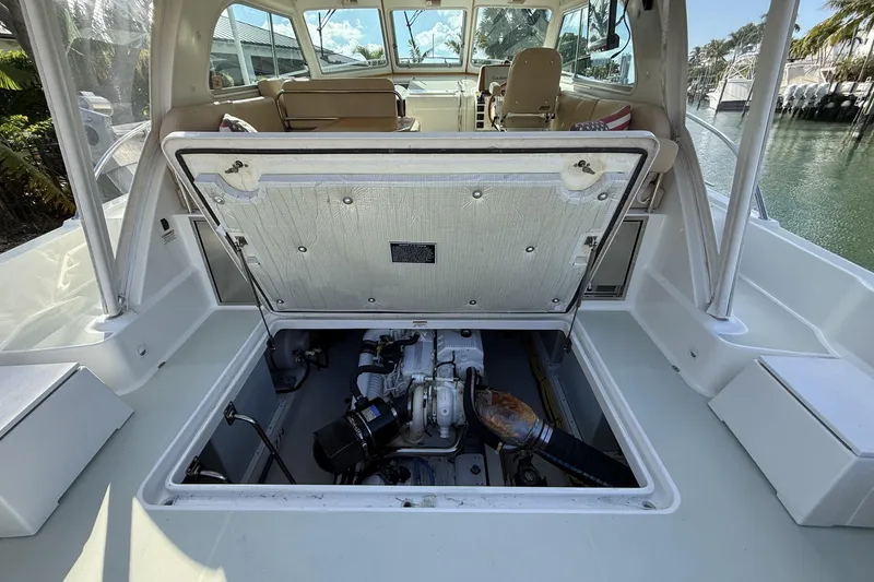 Slide: The Image of 2019 Back Cove Downeast 37 boat engine compartment with open hatch, dockside view. - 14