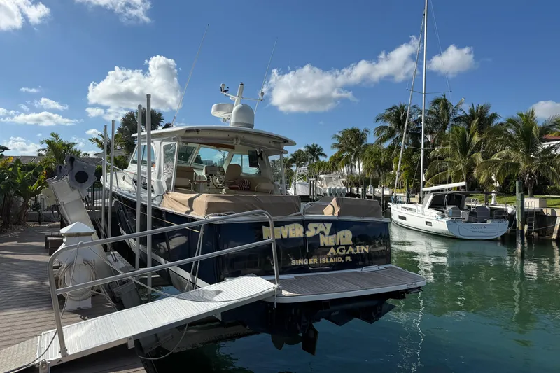 Slide: The Image of 2019 Back Cove Downeast 37 docked in a tropical marina setting. - 19