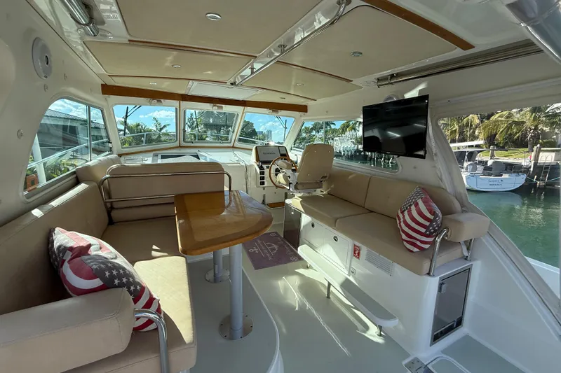 Slide: The Image of Interior of 2019 Back Cove Downeast 37 yacht with seating, table, and helm. - 4