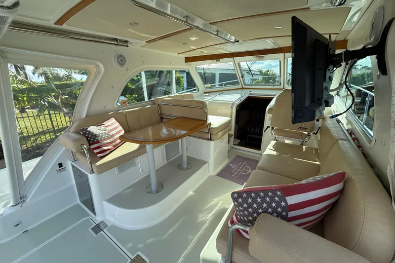 Slide: The Image of Interior of 2019 Back Cove Downeast 37 yacht with seating, table, and TV. - 5