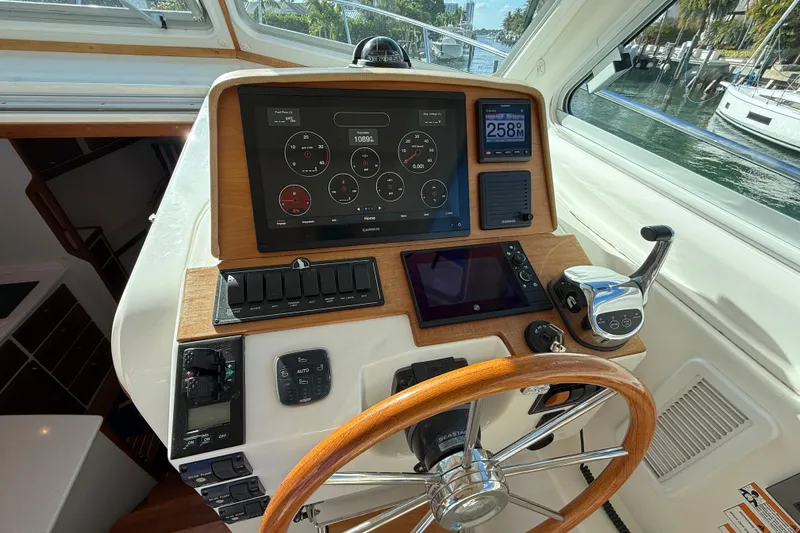 Slide: The Image of 2019 Back Cove Downeast 37 helm with modern navigation instruments and wooden steering wheel. - 6