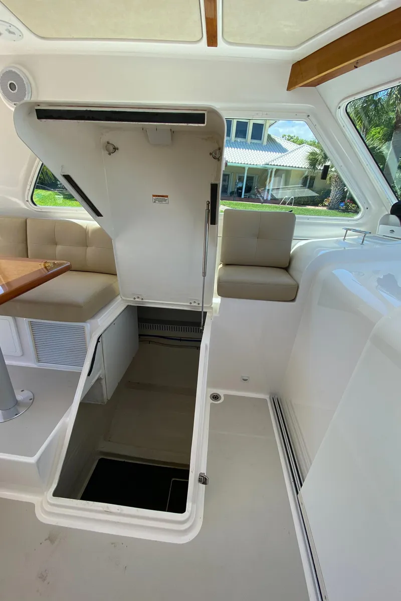 Slide: The Image of 2019 Back Cove Downeast 37 interior with open hatch, seating, and table. - 7