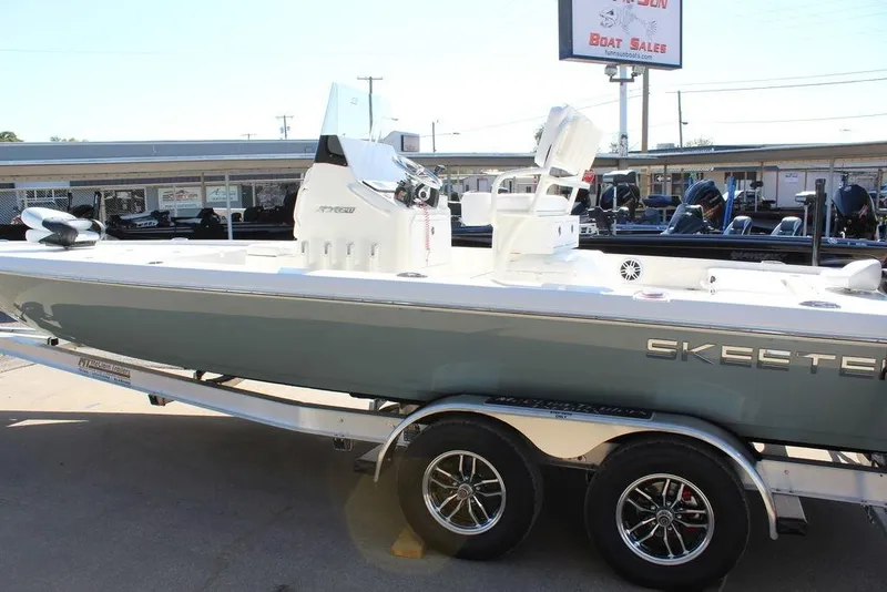 Slide: The Image of 2026 Skeeter SX241 boat on trailer at dealership, showcasing sleek design and modern features. - 11