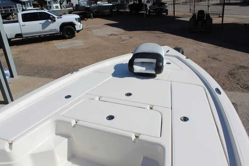 Slide: The Image of 2026 Skeeter SX241 boat deck with storage compartments, parked near a white truck. - 16