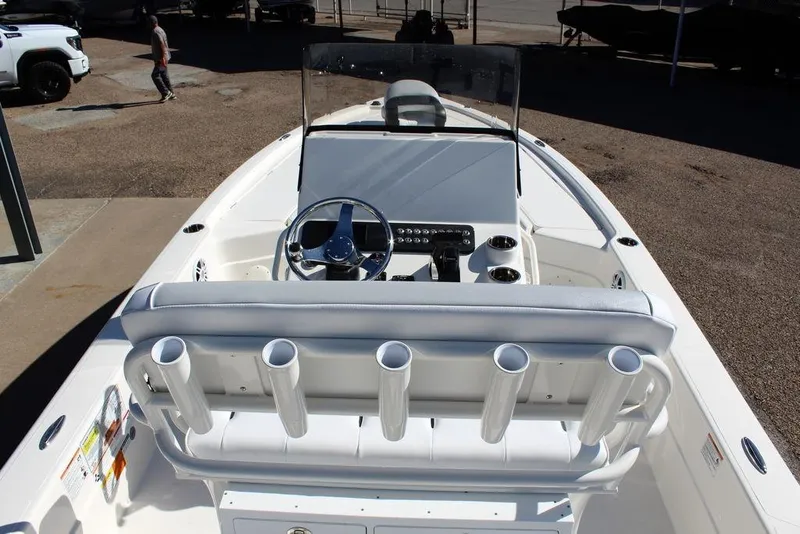 Slide: The Image of 2026 Skeeter SX241 boat interior with steering wheel, rod holders, and console. - 17