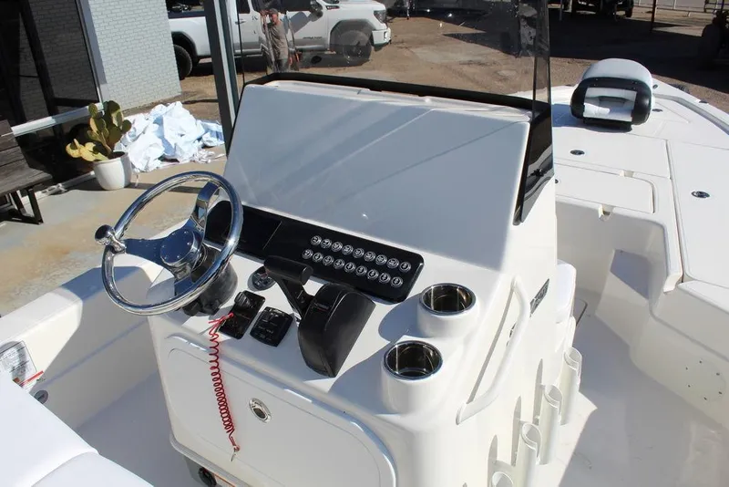 Slide: The Image of 2026 Skeeter SX241 boat console with steering wheel and control panel. - 19