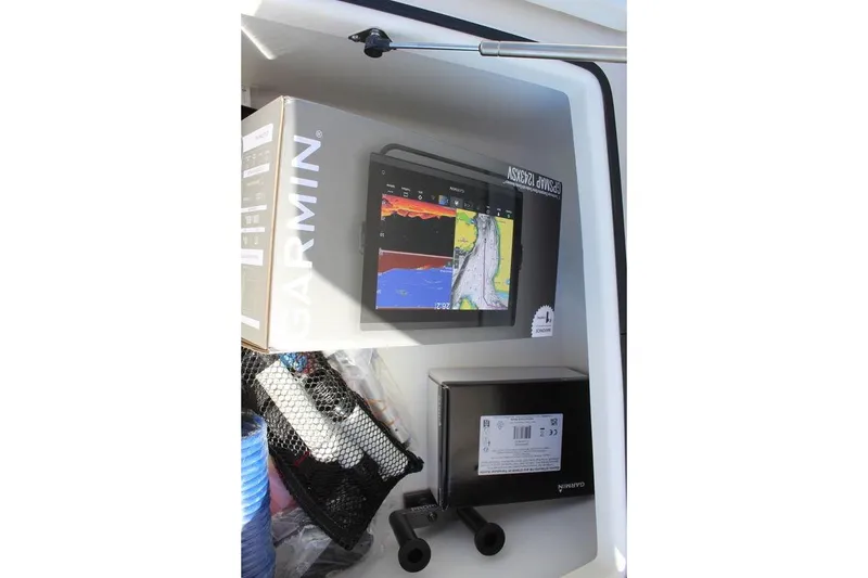 Slide: The Image of Boxed Garmin marine electronics inside a 2026 Skeeter SX241 boat compartment. - 22