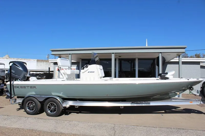 Slide: The Image of 2026 Skeeter SX241 boat on trailer, parked outside a building under clear blue sky. - 5