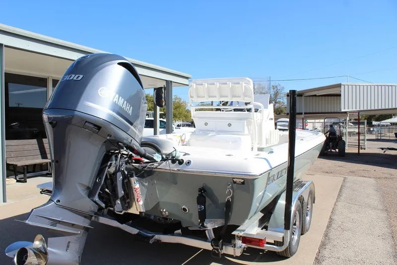 Slide: The Image of 2026 Skeeter SX241 boat with Yamaha engine on trailer, parked outdoors. - 6