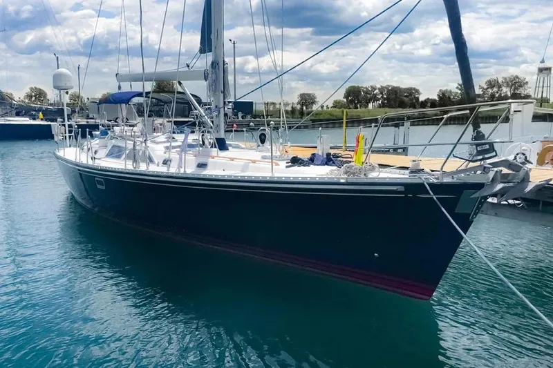 The Image of Sailing yacht Hylas 54, 1999 model, docked in a marina under a cloudy sky. - 1