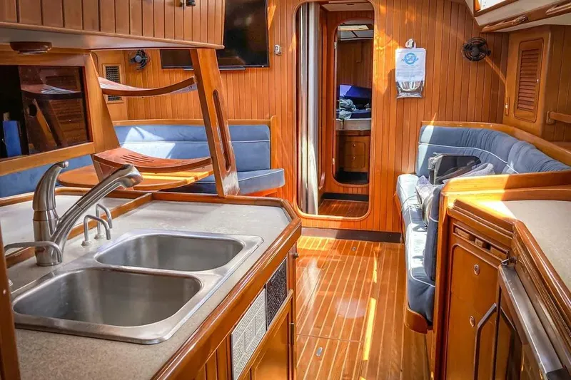 Slide: The Image of Luxurious 1999 Hylas 54 yacht interior with wood finish and modern amenities. - 11