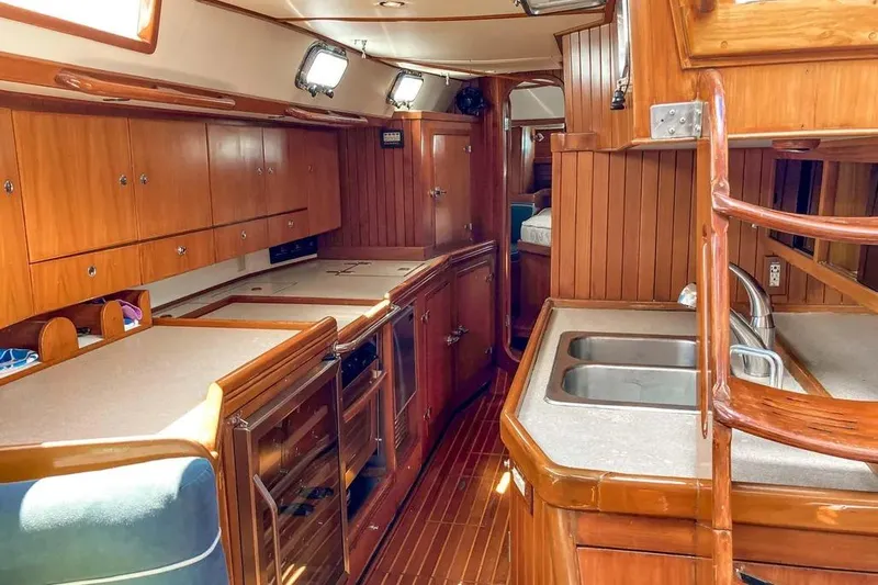 Slide: The Image of Interior of 1999 Hylas 54 yacht with wooden cabinetry and dual sinks. - 13